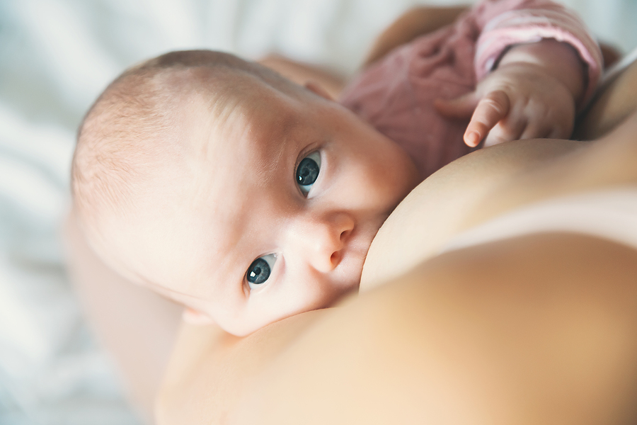 Baby feeding peacefully with mother