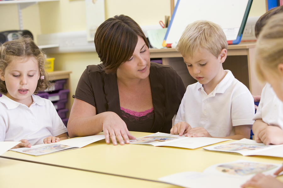 Teacher reading with a small group of young children